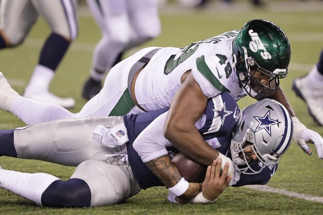 New York Jets' Jordan Jenkins, top, takes down Dallas Cowboys quarterback Dak Prescott during the second half of an NFL football game, Sunday, Oct. 13, 2019, in East Rutherford, N.J. The Jets defeated the Cowboys 24-22. (AP Photo/Frank Franklin II)