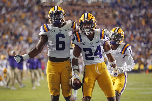 LSU cornerback Derek Stingley Jr. (24) celebrates his interception in the end zone with linebacker Brenton Cox Jr. (6) in the second half of an NCAA college football game against Florida in Baton Rouge, La., Saturday, Oct. 12, 2019. LSU won 42-28. (AP Photo/Gerald Herbert)