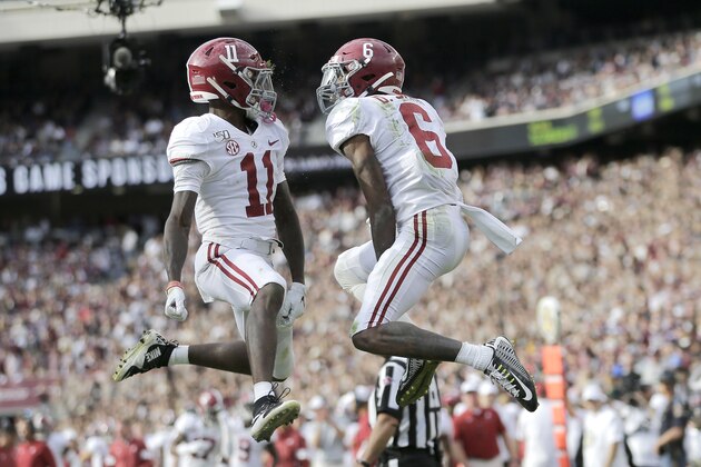 Alabama wide receiver Henry Ruggs III (11) and wide receiver DeVonta Smith (6) react after Ruggs' 33-yard catch and run touchdown against Texas A&M during the third quarter of an NCAA college football game, Saturday, Oct. 12, 2019, in College Station, Texas. (AP Photo/Sam Craft)