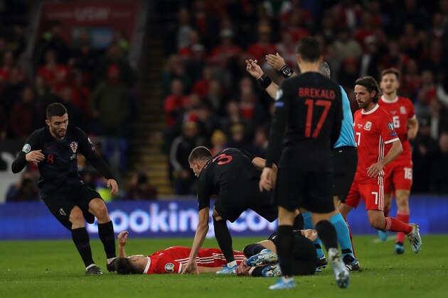 CARDIFF, WALES - OCTOBER 13: Daniel James of Wales lies on the ground knocked out during the UEFA Euro 2020 qualifier between Wales and Croatia at Cardiff City Stadium on October 13, 2019 in Cardiff, Wales. (Photo by Matthew Ashton - AMA/Getty Images)