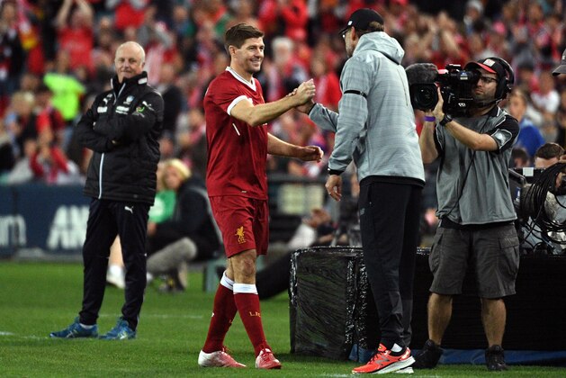 Liverpool player Steven Gerrard (2nd L) shakes hands with coach Jurgen Klopp after being substituted during their end-of-season friendly football match against Sydney FC at the Olympic Stadium in Sydney on May 24, 2017. / AFP PHOTO / WILLIAM WEST        (Photo credit should read WILLIAM WEST/AFP/Getty Images)