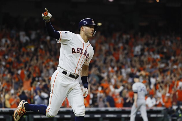 Houston Astros' Carlos Correa celebrates with teammates after his walk-off home run against the New York Yankees during the 11th inning in Game 2 of baseball's American League Championship Series Sunday, Oct. 13, 2019, in Houston. (AP Photo/Matt Slocum)