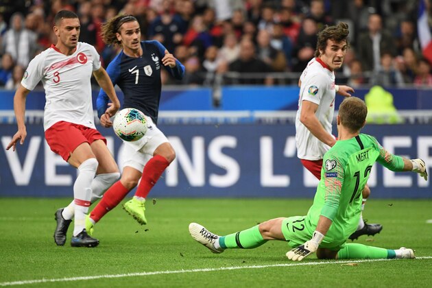 Turkey's goalkeeper Mert Gunok (R) clears the ball past Turkey's defender Merih Demiral (L) and France's forward Antoine Griezmann (2ndL) during the Euro 2020 Group H qualification football match between France and Turkey at the Stade de France in Saint-Denis, outside Paris on October 14, 2019. (Photo by Alain JOCARD / AFP) (Photo by ALAIN JOCARD/AFP via Getty Images)