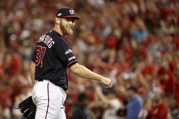 WASHINGTON, DC - OCTOBER 14: Stephen Strasburg #37 of the Washington Nationals smiles as he walks back to the dug out in the fifth inning of game three of the National League Championship Series against the St. Louis Cardinals at Nationals Park on October 14, 2019 in Washington, DC. (Photo by Patrick Smith/Getty Images)