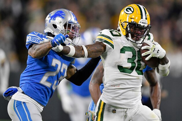 GREEN BAY, WISCONSIN - OCTOBER 14: Jamaal Williams #30 of the Green Bay Packers runs in the second quarter against Darius Slay #23 of the Detroit Lions at Lambeau Field on October 14, 2019 in Green Bay, Wisconsin. (Photo by Quinn Harris/Getty Images)