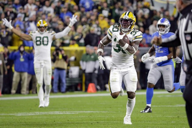 Green Bay Packers running back Jamaal Williams (30) rushes for long yardage during the first half of an NFL football game against the Detroit Lions, Monday, Oct. 14, 2019, in Green Bay, Wis. (AP Photo/Mike Roemer)