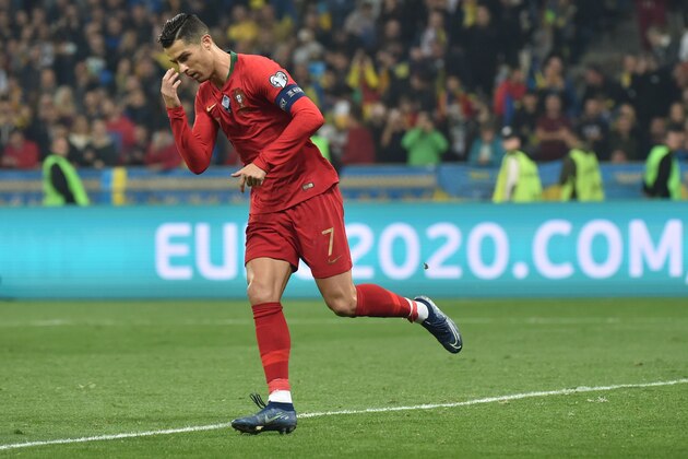 Portugal's forward Cristiano Ronaldo celebrates after scoring a goal from the penalty spot during the Euro 2020 football qualification match between Ukraine and Portugal at the NSK Olimpiyskyi stadium in Kiev on October 14, 2019. (Photo by Genya SAVILOV / AFP) (Photo by GENYA SAVILOV/AFP via Getty Images)