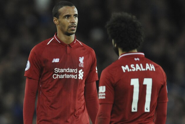 Liverpool's Joel Matip, left, and his teammate Mohamed Salah stand at the end of the English Premier League soccer match between Everton and Liverpool at Goodison Park in Liverpool, England, Sunday, March 3, 2019. (AP Photo/Rui Vieira)