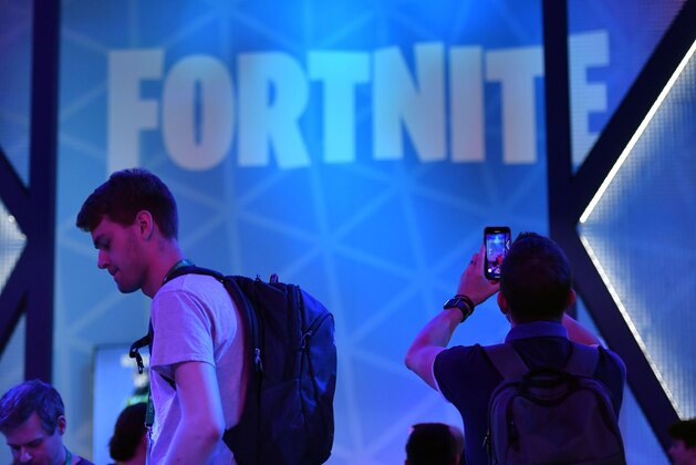 A visitor takes pictures at the stand of the