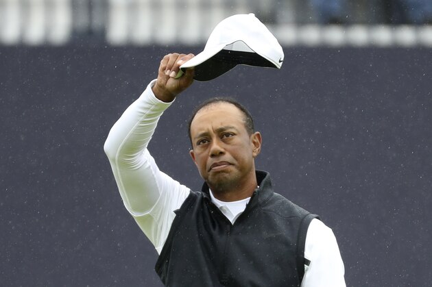 Tiger Woods of the United States waves his hat to the crowd as he completes his second round of the British Open Golf Championships at Royal Portrush in Northern Ireland, Friday, July 19, 2019. Woods finished at 6 over par for the two rounds. (AP Photo/Peter Morrison)