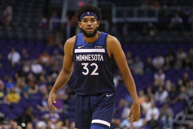 Minnesota Timberwolves center Karl-Anthony Towns (32) in the first half during a preseason NBA basketball game against the Phoenix Suns, Tuesday, Oct. 8, 2019, in Phoenix. (AP Photo/Rick Scuteri)