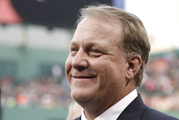 FILE - This Aug. 3, 2012, file photo, shows former Boston Red Sox pitcher Curt Schilling smiling after being introduced at Fenway Park in Boston. Schilling says he might challenge Democratic U.S. Rep. Tom O'Halleran if he runs in Arizona. The Arizona Republic reported Wednesday, Aug. 21, 2019, that Schilling announced last week that he's thinking about running for Congress and has reached out to the Arizona Republican Party. (AP Photo/Winslow Townson, File)
