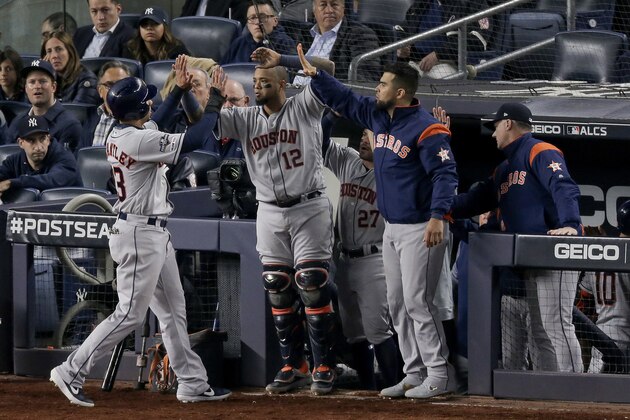 Houston Astros' Michael Brantley (23) is congratulated by teammates after scoring against the New York Yankees during the seventh inning of Game 3 of baseball's American League Championship Series, Tuesday, Oct. 15, 2019, in New York. (AP Photo/Seth Wenig)