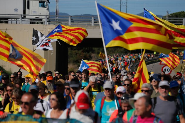 Protesters walk on the AP-7 highway near Girona, on October 16, 2019, a day after police arrested 51 people across Catalonia overnight after violent protests over the jailing of nine separatist leaders for their role in a failed 2017 independence bid. (Photo by Pau Barrena / AFP) (Photo by PAU BARRENA/AFP via Getty Images)