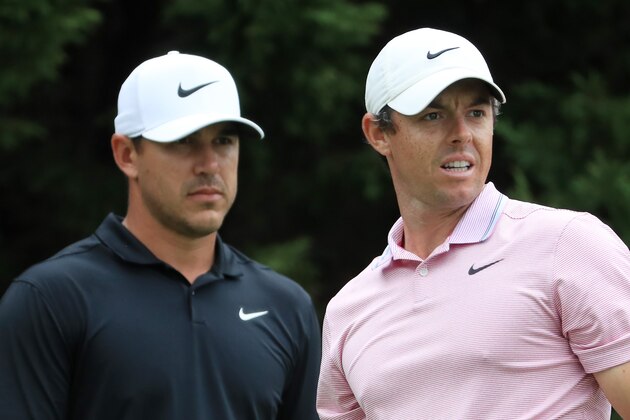 ATLANTA, GEORGIA - AUGUST 25: Brooks Koepka of the United States and Rory McIlroy of Northern Ireland look on from the eighth tee during the final round of the TOUR Championship at East Lake Golf Club on August 25, 2019 in Atlanta, Georgia. (Photo by Streeter Lecka/Getty Images)