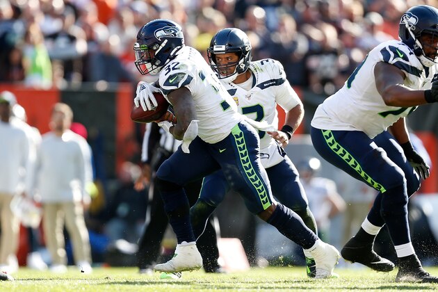 CLEVELAND, OH - OCTOBER 13:  Chris Carson #32 of the Seattle Seahawks takes the ball from Russell Wilson #3 during the game against the Cleveland Browns at FirstEnergy Stadium on October 13, 2019 in Cleveland, Ohio. Seattle defeated Cleveland 32-28. (Photo by Kirk Irwin/Getty Images)
