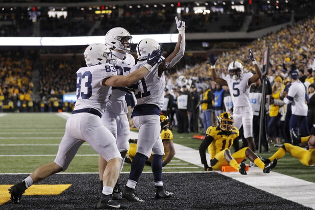 Penn State running back Noah Cain, center, celebrates his touchdown during the second half of the team's NCAA college football game against Iowa on Saturday, Oct. 12, 2019, in Iowa City, Iowa. (AP Photo/Matthew Putney)