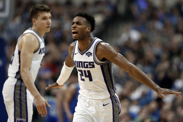 Sacramento Kings guard Buddy Hield (24) celebrates with Bogdan Bogdanovic, left, after sinking a three-point basket in the second half of an NBA basketball game against the Dallas Mavericks in Dallas, Tuesday, March 26, 2019. (AP Photo/Tony Gutierrez)