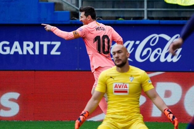 Barcelona's Argentinian forward Lionel Messi (back) celebrates past Eibar's Serbian goalkeeper Marko Dmitrovic after scoring a goal during the Spanish League football match between Eibar and Barcelona at the Ipurua stadium in Eibar on May 19, 2019. (Photo by STRINGER / AFP)        (Photo credit should read STRINGER/AFP/Getty Images)