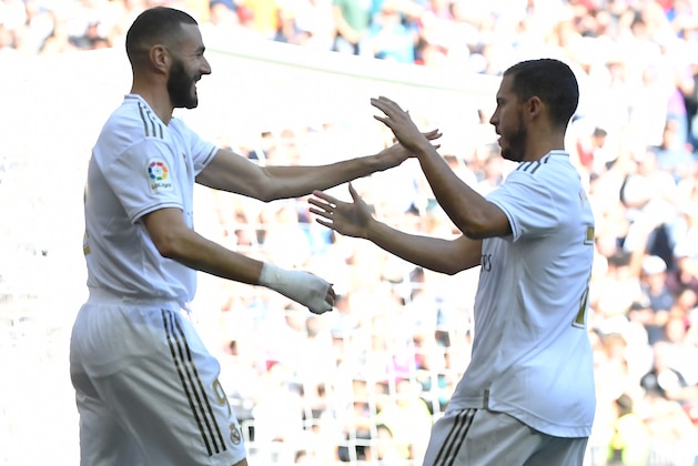 Real Madrid's French forward Karim Benzema (L) celebrates scoring the opening goal with Real Madrid's Belgian forward Eden Hazard during the Spanish league football match between Real Madrid CF and Granada FC at the Santiago Bernabeu stadium in Madrid on October 5, 2019. (Photo by PIERRE-PHILIPPE MARCOU / AFP) (Photo by PIERRE-PHILIPPE MARCOU/AFP via Getty Images)