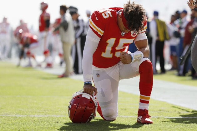 Kansas City Chiefs quarterback Patrick Mahomes (15) takes a knee before the first half of an NFL football game against the Houston Texans in Kansas City, Mo., Sunday, Oct. 13, 2019. (AP Photo/Colin E. Braley)
