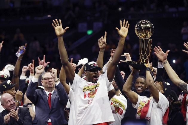 Toronto Raptors center Serge Ibaka, middle, and teammates celebrate after defeating the Golden State Warriors in Game 6 of basketball's NBA Finals in Oakland, Calif., Thursday, June 13, 2019. (AP Photo/Ben Margot)