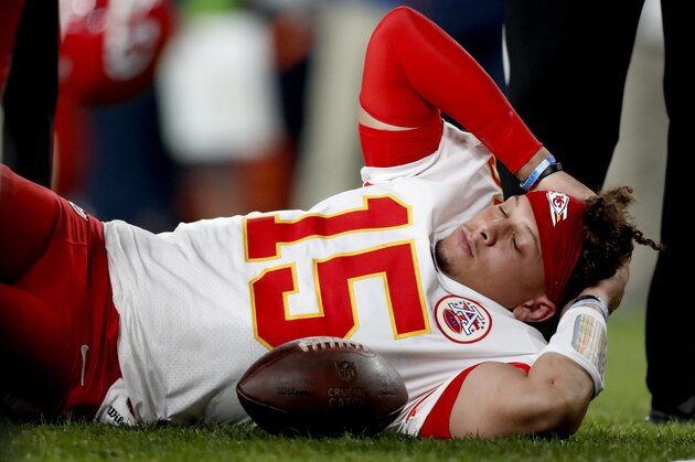 Kansas City Chiefs quarterback Patrick Mahomes (15) lies on the field after being injured against the Denver Broncos during the first half of an NFL football game, Thursday, Oct. 17, 2019, in Denver. (AP Photo/David Zalubowski)