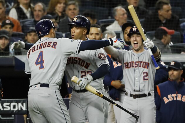 Houston Astros' George Springer (4), left, celebrates after his three-run home run off New York Yankees starting pitcher Masahiro Tanaka during the third inning in Game 4 of baseball's American League Championship Series Thursday, Oct. 17, 2019, in New York. (AP Photo/Matt Slocum)