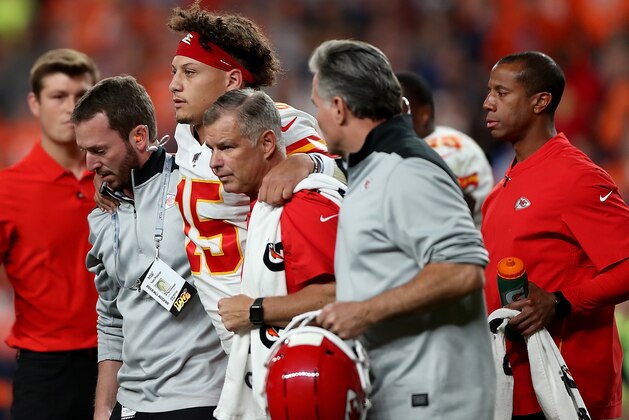 DENVER, COLORADO - OCTOBER 17: Quarterback Patrick Mahomes #15 of the Kansas City Chiefs is escorted offs the field after an injury on the first half against the Denver Broncos in the game at Broncos Stadium at Mile High on October 17, 2019 in Denver, Colorado. (Photo by Matthew Stockman/Getty Images)