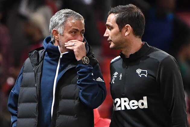 Manchester United's Portuguese manager Jose Mourinho (L) talks with Derby's English manager Frank Lampard at the half-time break in the English League Cup third round football match between Manchester United and Derby County at Old Trafford in Manchester, north west England, on September 25, 2018. (Photo by Paul ELLIS / AFP) / RESTRICTED TO EDITORIAL USE. No use with unauthorized audio, video, data, fixture lists, club/league logos or 'live' services. Online in-match use limited to 120 images. An additional 40 images may be used in extra time. No video emulation. Social media in-match use limited to 120 images. An additional 40 images may be used in extra time. No use in betting publications, games or single club/league/player publications. /         (Photo credit should read PAUL ELLIS/AFP/Getty Images)