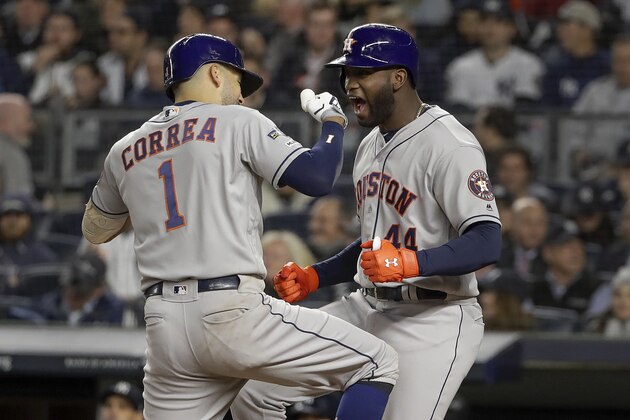 Houston Astros' Carlos Correa (1) celebrates with designated hitter Yordan Alvarez (44) after hitting a three-run home run against the New York Yankees during the sixth inning of Game 4 of baseball's American League Championship Series, Thursday, Oct. 17, 2019, in New York. (AP Photo/Frank Franklin II)