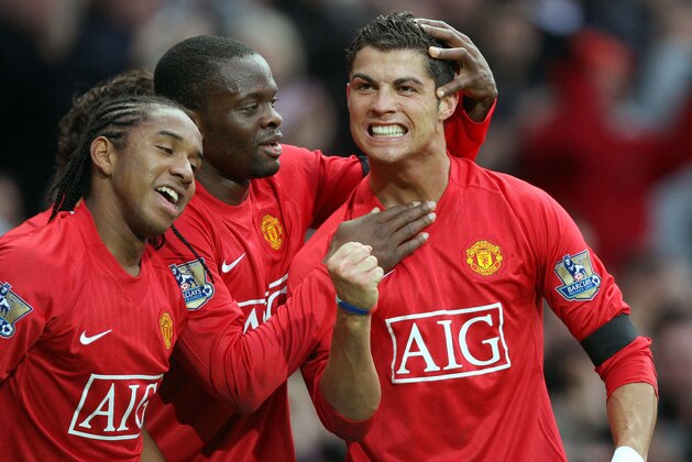 Cristiano Ronaldo (R) of Manchester United celebrates scoring with Louis Saha (C) and Anderson during the Premier league football match against Blackburn Rovers at Old Trafford, Manchester , north-west England, 11 October 2007. AFP PHOTO/ANDREW YATES  Mobile and website use of domestic English football pictures are subject to obtaining a Photographic End User Licence from Football DataCo Ltd Tel : +44 (0) 207 864 9121 or e-mail accreditations@football-dataco.com - applies to Premier and Football League matches. (Photo credit should read ANDREW YATES/AFP/Getty Images)