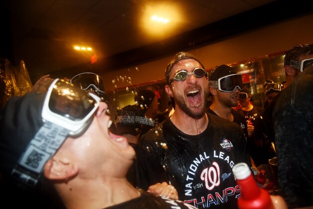 WASHINGTON, DC - OCTOBER 15: Max Scherzer #31 of the Washington Nationals celebrates with teammates in the clubhouse after they won game four and the National League Championship Series against the St. Louis Cardinals at Nationals Park on October 15, 2019 in Washington, DC. (Photo by Will Newton/Getty Images)