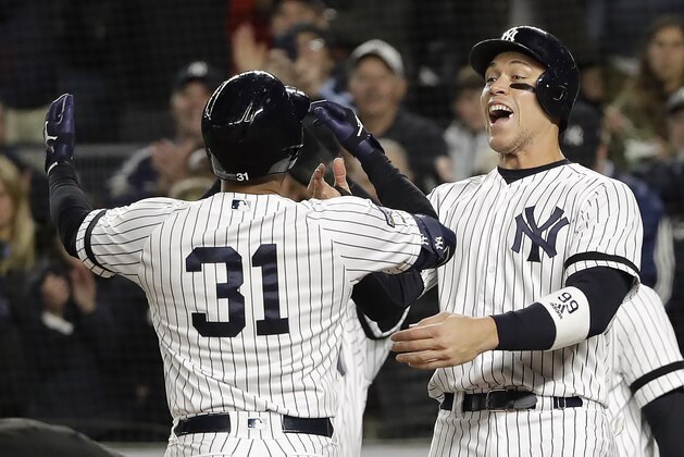 New York Yankees center fielder Aaron Hicks (31) celebrates with Aaron Judge after hitting a three-run home run against the Houston Astros during the first inning of Game 5 of baseball's American League Championship Series, Friday, Oct. 18, 2019, in New York. (AP Photo/Frank Franklin II)