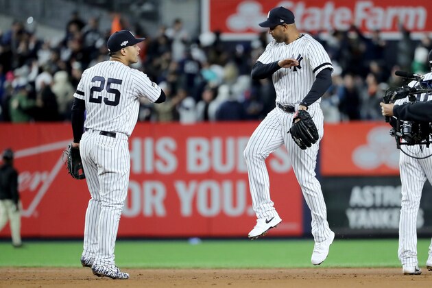 NEW YORK, NEW YORK - OCTOBER 18: Gleyber Torres #25 and Aaron Hicks #31 of the New York Yankees celebrate after defeating the Houston Astros in game five of the American League Championship Series with a score of 4 to 1 at Yankee Stadium on October 18, 2019 in New York City. (Photo by Elsa/Getty Images)