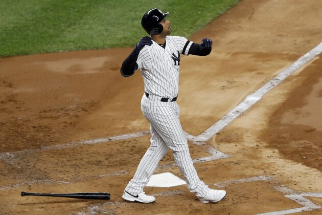 New York Yankees' Aaron Hicks watches his three-run home run against the Houston Astros during the first inning in Game 5 of baseball's American League Championship Series Friday, Oct. 18, 2019, in New York. (AP Photo/Kathy Willens)