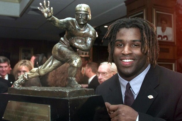 NEW YORK, NY - DECEMBER 12:  Texas tailback Ricky Williams, winner of the 1998 Heisman trophy,  poses with US college football's highest honor 12 December at the Downtown Athletic Club in New York. Williams ran for 2,124 yards and broke Tony Dorsett's 22-year-old record career rushing record as he led the Longhorns to an 8-3 record and a trip to the Cotton Bowl  on 01 January 1999.  (Photo credit should read ADAM NADEL/AFP via Getty Images)