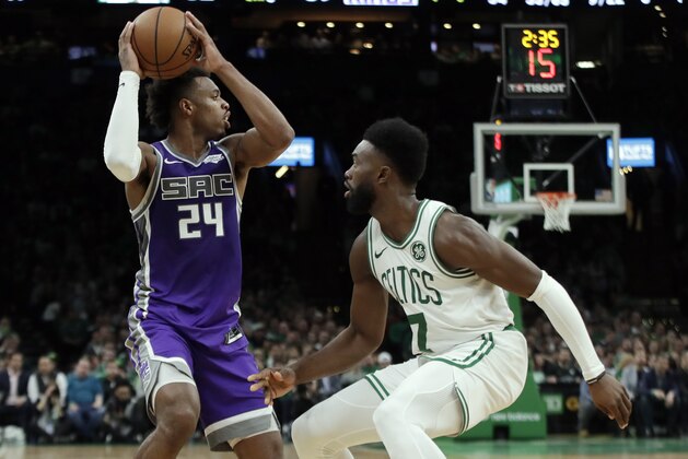 Sacramento Kings guard Buddy Hield (24) looks for room against Boston Celtics guard Jaylen Brown (7) in the second half of an NBA basketball game, Thursday, March 14, 2019, in Boston. (AP Photo/Elise Amendola)