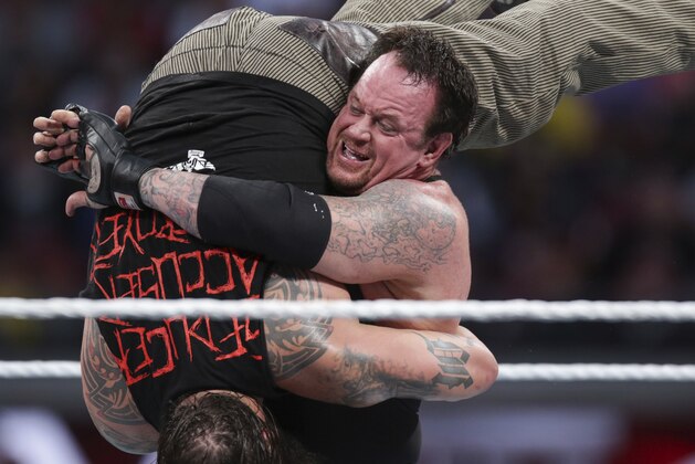 FILE - In this March 29, 2015, file photo, Bray Wyatt is upended by his opponent, The Undertaker, at Wrestlemania XXXI in Santa Clara, Calif. The WWE is set for its annual sports entertainment extravaganza Sunday, April 1, 2017,  in Orlando, Fla. John Cena, the Undertaker, the Miz and the Bella Twins all have big matches on the show.  (AP Photo/Don Feria, File)