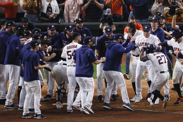 Houston Astros celebrate Jose Altuve's walk-off in Game 6 of baseball's American League Championship Series against the New York Yankees Saturday, Oct. 19, 2019, in Houston. The Astros won 6-4 to win the series 4-2. (AP Photo/Sue Ogrocki)