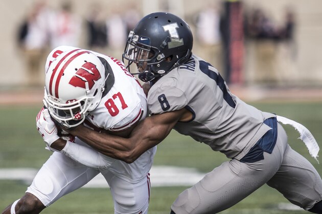 Illinois defender Nate Hobbs (8) takes down Wisconsin's Quintez Cephus (87) in the second half of an NCAA college football game, Saturday, Oct.19, 2019, in Champaign, Ill. (AP Photo/Holly Hart)