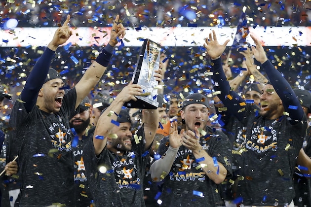 Houston Astros second baseman Jose Altuve holds the trophy after Game 6 of baseball's American League Championship Series against the New York Yankees Saturday, Oct. 19, 2019, in Houston. The Astros won 6-4 to win the series 4-2. (AP Photo/Matt Slocum)