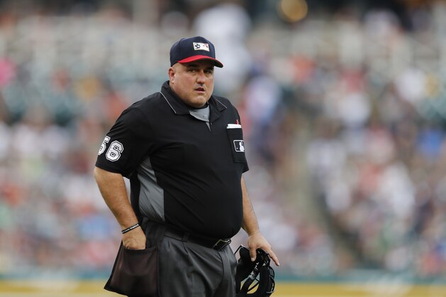 Home plate umpire Eric Cooper stands near the mound during the third inning of a baseball game between the Detroit Tigers and the Boston Red Sox, Friday, July 5, 2019, in Detroit. (AP Photo/Carlos Osorio)