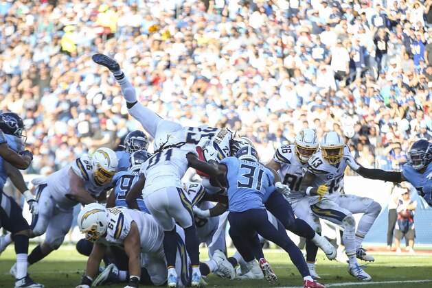 NASHVILLE, TENNESSEE - OCTOBER 20: Melvin Gordon III #25 of the Los Angeles Chargers dives over players in an attempt to score a touchdown against the Tennessee Titans during the second quarter at Nissan Stadium on October 20, 2019 in Nashville, Tennessee. (Photo by Silas Walker/Getty Images)