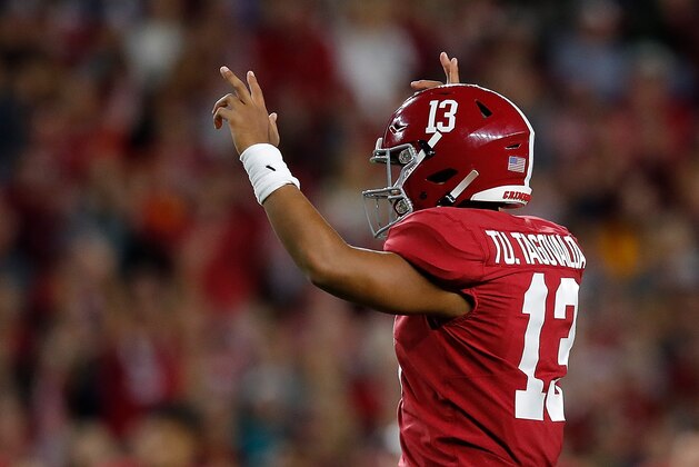 TUSCALOOSA, ALABAMA - OCTOBER 19:  Tua Tagovailoa #13 of the Alabama Crimson Tide reacts after a rushing touchdown by Brian Robinson Jr. #24 in the first half against the Tennessee Volunteers at Bryant-Denny Stadium on October 19, 2019 in Tuscaloosa, Alabama. (Photo by Kevin C. Cox/Getty Images)
