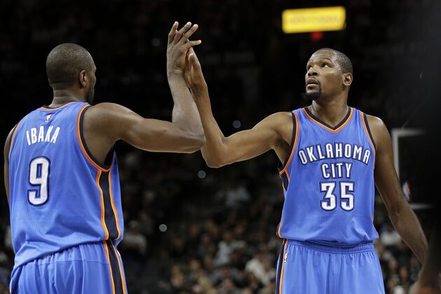 Oklahoma City Thunder's Serge Ibaka (9) and Kevin Durant (35) hi-five each other during the second half in Game 2 of a second-round NBA basketball playoff series against the San Antonio Spurs on Monday, May 2, 2016, in San Antonio. (AP Photo/Eric Gay)