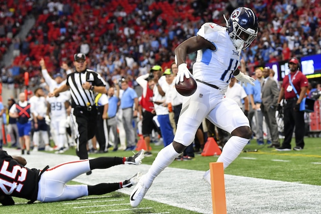 Tennessee Titans wide receiver A.J. Brown (11) scores a touchdown against Atlanta Falcons linebacker Deion Jones (45) during the first half of an NFL football game, Sunday, Sept. 29, 2019, in Atlanta. (AP Photo/John Amis)