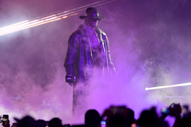 TOPSHOT - World Wrestling Entertainment star The Undertaker makes his way to the ring during a match at the World Wrestling Entertainment (WWE) Super Showdown event in the Saudi Red Sea port city of Jeddah late on January 7, 2019. (Photo by Amer HILABI / AFP)        (Photo credit should read AMER HILABI/AFP/Getty Images)