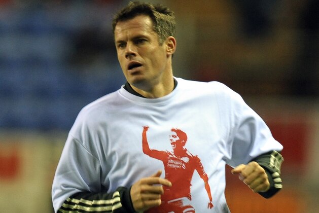 Liverpool's English defender Jamie Carragher warms up wearing a t-shirt supporting team-mate Luis Suarez (not pictured) before the English Premier League football match between Wigan Athletic and Liverpool at The DW Stadium in Wigan, north-west England on December 21, 2011. AFP PHOTO/PAUL ELLIS

RESTRICTED TO EDITORIAL USE. No use with unauthorized audio, video, data, fixture lists, club/league logos or “live” services. Online in-match use limited to 45 images, no video emulation. No use in betting, games or single club/league/player publications (Photo credit should read PAUL ELLIS/AFP/Getty Images)