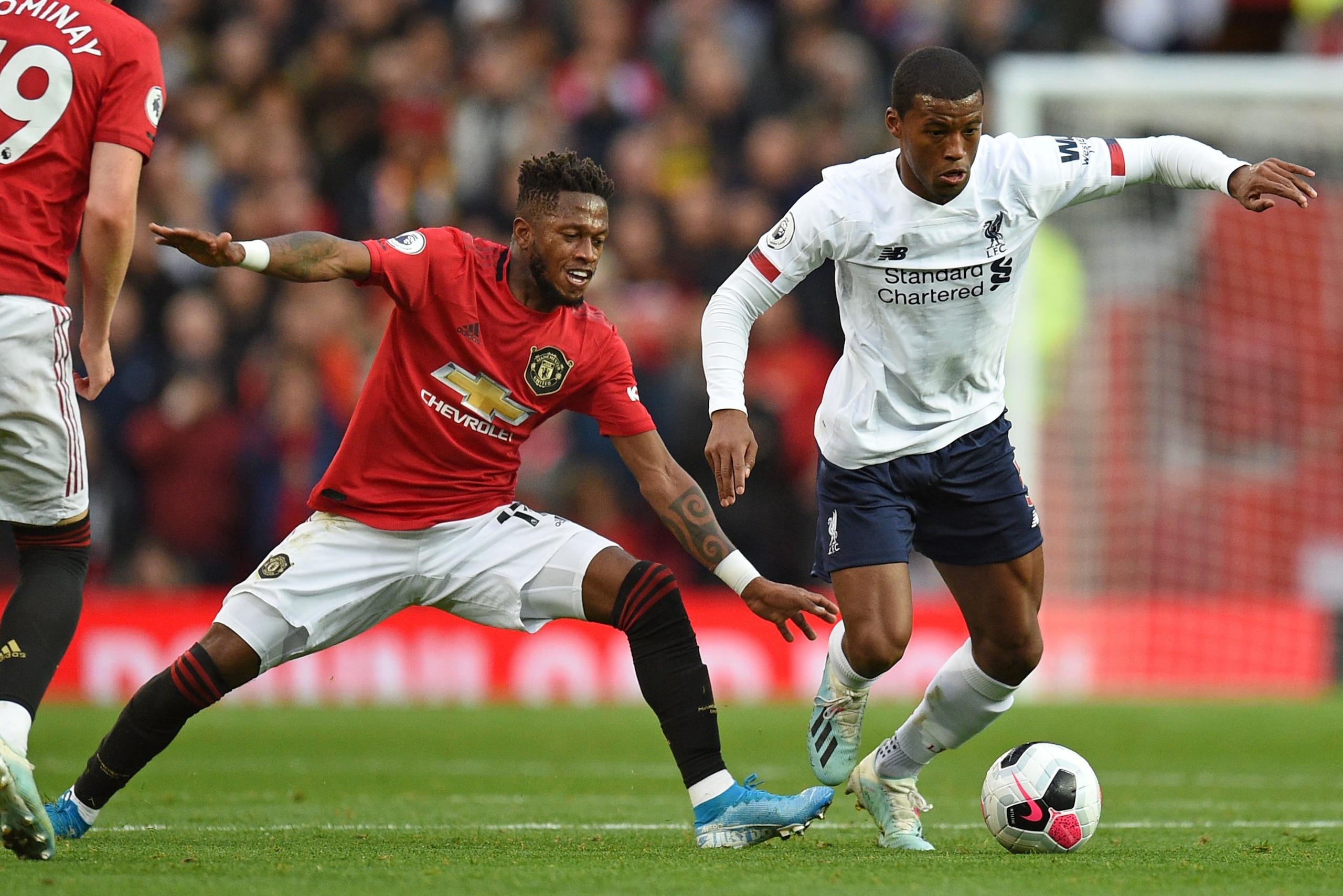TOPSHOT - Manchester United's Brazilian midfielder Fred (L) vies with Liverpool's Dutch midfielder Georginio Wijnaldum (R) during the English Premier League football match between Manchester United and Liverpool at Old Trafford in Manchester, north west England, on October 20, 2019. (Photo by Oli SCARFF / AFP) / RESTRICTED TO EDITORIAL USE. No use with unauthorized audio, video, data, fixture lists, club/league logos or 'live' services. Online in-match use limited to 120 images. An additional 40 images may be used in extra time. No video emulation. Social media in-match use limited to 120 images. An additional 40 images may be used in extra time. No use in betting publications, games or single club/league/player publications. /  (Photo by OLI SCARFF/AFP via Getty Images)